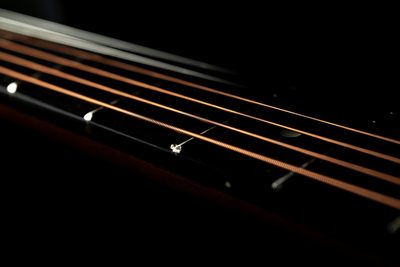 close-up view of guitar strings and frets